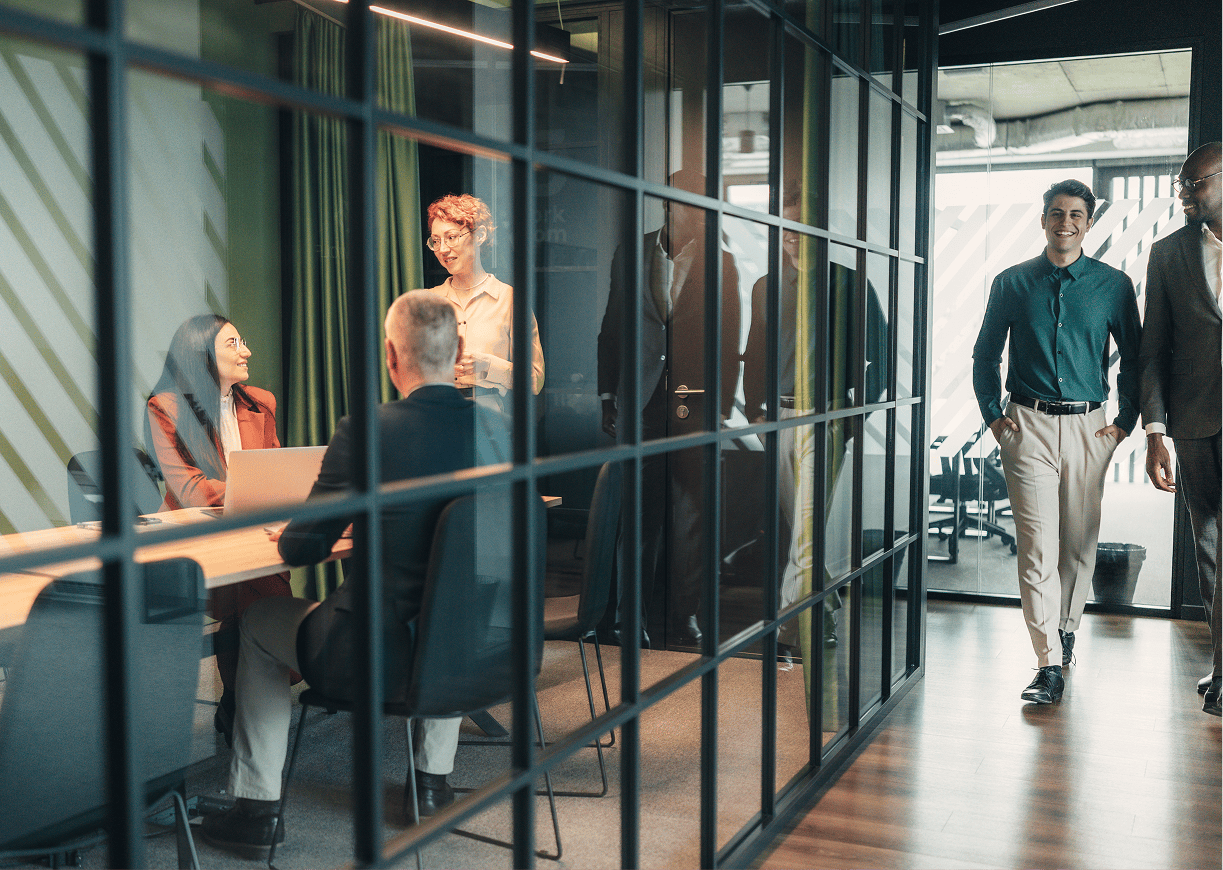 Office meeting with people discussing and walking.