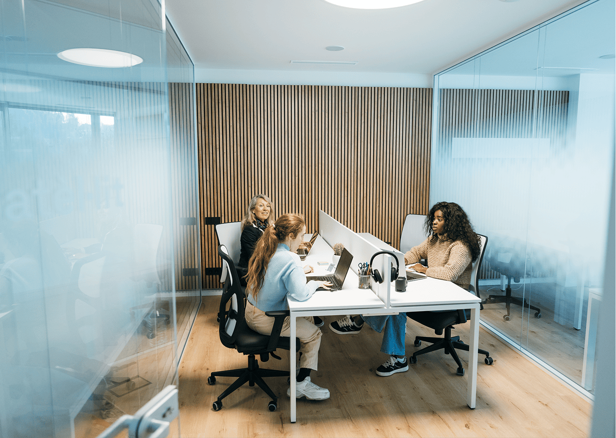 Women working in a modern glass office.
