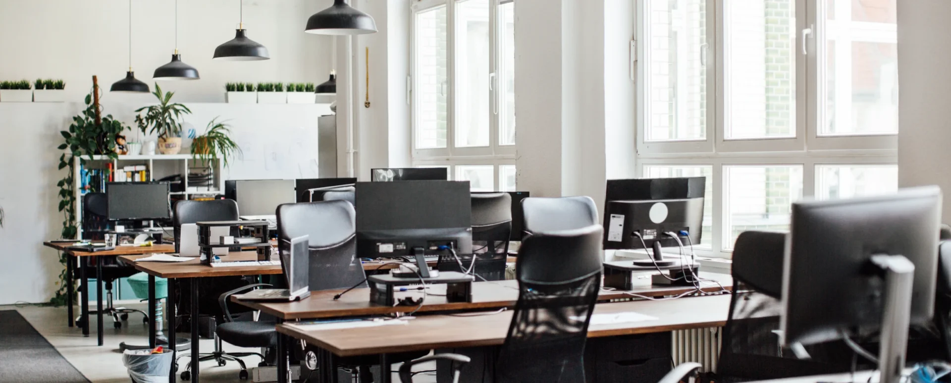 Modern open-plan office with empty desks.