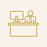 Icon of person sitting at a desk.
